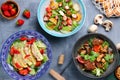 Table with many meal, meat and salad and ingredients top view. Different salads octopus with potatoe, chicken with mango salad and Royalty Free Stock Photo