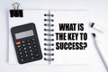 On the table are a marker, a calculator and a notebook with the inscription - What is the Key to Success Royalty Free Stock Photo