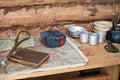 Table with military map, winter hat and utensils partisan dugout