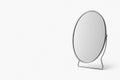 Table mirror on a light background. Space for text. Royalty Free Stock Photo