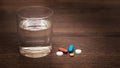 On the table near a glass of water are pills. It`s time to take your medicine_ Royalty Free Stock Photo