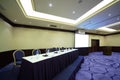 Table near screen in conference hall Royalty Free Stock Photo