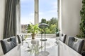 Table near the window in the dining room of a modern apartment Royalty Free Stock Photo