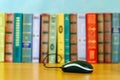 On the table a number of books and a mouse from the laptop. Royalty Free Stock Photo