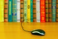 On the table a number of books and a mouse from the laptop. Royalty Free Stock Photo