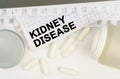 On the table is an open jar of pills and a sheet of paper with the inscription - Kidney Disease Royalty Free Stock Photo