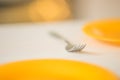 Table with orange plates and fork closeup, ready for food time Royalty Free Stock Photo