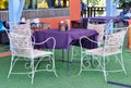 Table in an outdoor porch with cozy chairs