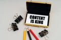 On the table are pencils and a business card holder, inside a business card with the inscription - CONTENT IS KING