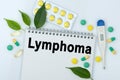 On the table are pills, a thermometer, leaves and a notebook with the inscription -Lymphoma Royalty Free Stock Photo