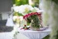 The table with roses in a glass vase and wedding bouquet Royalty Free Stock Photo