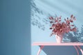 Table with plant in vase against blue wall background. Generative AI Royalty Free Stock Photo