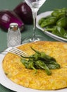 Table with a plate containing a Spanish omelette.