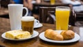 A table with a plate of croissants, a glass of beer, a cup of coffee, and a glass of orange juice Royalty Free Stock Photo