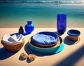 A table with plates and cups and a plate with a napkin on it. Beach