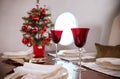 Table with plates and red glasses Christmas tree ,the cabin of the aircraft