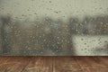 Table on rainy window background Royalty Free Stock Photo