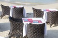 Table and rattan chairs in empty cafe next to the sea water on the beach, Thailand. Close up Royalty Free Stock Photo