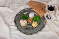 Table ready for traditional seder plate ritual the Jewish holiday of Passover. Kiddush cup, haggada, matzos, lettuce