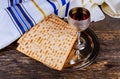 Table ready for traditional seder plate ritual the Jewish holiday of Passover. Kiddush cup, haggada, matzos, lettuce