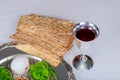 Table ready for traditional seder plate ritual the Jewish holiday of Passover. Kiddush cup, haggada, matzos, lettuce