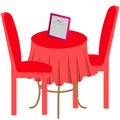 Table with red tablecloth. Nearby are two red chairs. Royalty Free Stock Photo