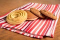 On the table on a red towel in striped cakes is to coffee: delicate cookies, fritters, and two oatmeal cookies