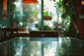 table with reflective surface, outoffocus cozy cafe nook behind