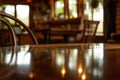 table with reflective surface, outoffocus cozy cafe nook behind