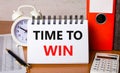 On the table are reports, a white alarm clock, a calculator, folders for papers, a pen and a white notebook with the text TIME TO Royalty Free Stock Photo