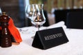 Table reservation in the restaurant. Booking a table in a restaurant. There is sign on the table that says Reserve. Royalty Free Stock Photo