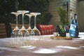 Table at restaurant with arranged empty wine glasses turned upside down and blurry background Royalty Free Stock Photo
