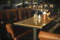 Table in restaurant. Place to relax. Brown sofa. Dining table Royalty Free Stock Photo