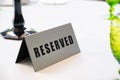 Table at restaurant with reserved sign close-up Royalty Free Stock Photo