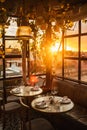 Table restaurant served for romantic dinner on rooftop terrace in sunset light Royalty Free Stock Photo