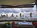 Table of a restaurant set on the beach facing the sea Royalty Free Stock Photo