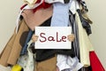 Table `SALE` is shown from inside of a big pile of different clothes