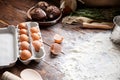 On the table, scattered flour, eggshell and tray with eggs. Royalty Free Stock Photo