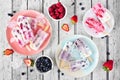 Above view table scene of homemade berry yogurt ice pops over rustic white wood Royalty Free Stock Photo