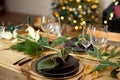 Table served for Christmas dinner in living room, close-up view, table setting, Christmas decoration. Royalty Free Stock Photo