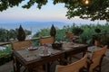 A table served for four persons with the sea view in the evening time on the Kefalonia island, Ionian sea, Greece