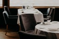 Table served for luxury dinner party with napkins, glasses and plates on white tableclothes. Nice decor. Wedding Banquet. Cozy atm Royalty Free Stock Photo