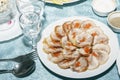 Table served with roll of poultry meat with vegetables filling. Empty clean wine glasses and delicious cold snack on festive table Royalty Free Stock Photo