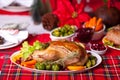 Table served for thanksgiving or Christmas dinner. Stuffed roasted turkey in the foreground. Traditional celebrating holiday Royalty Free Stock Photo