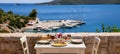 A table served for two with chicken souvlaki and french fries, greek salad, snacks and drinks on the summer terrace of the hotel r Royalty Free Stock Photo