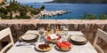 A table served for two with snacks and drinks on the summer terrace of the hotel room by the seascape. Royalty Free Stock Photo