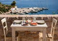 A table served for two with snacks and drinks on the summer terrace of the hotel room by the seascape. Royalty Free Stock Photo