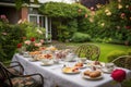 table set for afternoon tea, with delicate cups, pastries and rose garden in the background