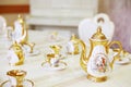 Table with set of beautiful porcelain dishes in