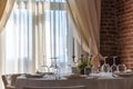 Table set with candles in a luxurious restaurant with brick wall